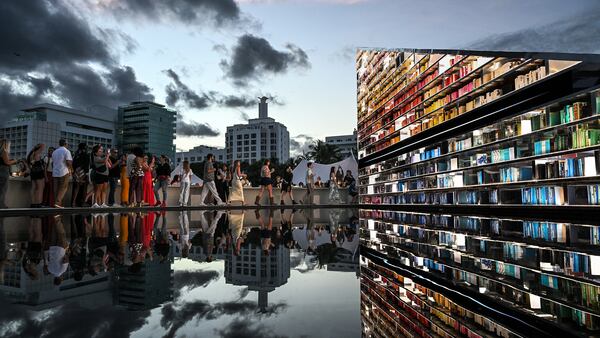 “Library of Us,” a rotating triangular installation by Es Devlin, invited Art Basel Miami Beach attendees to peruse the artist’s bookshelf.