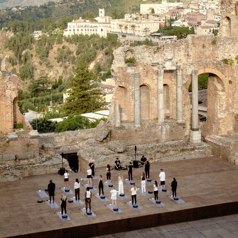 Vogue France's May 2026 wellness retreat yoga class at an ancient Greek amphitheatre
