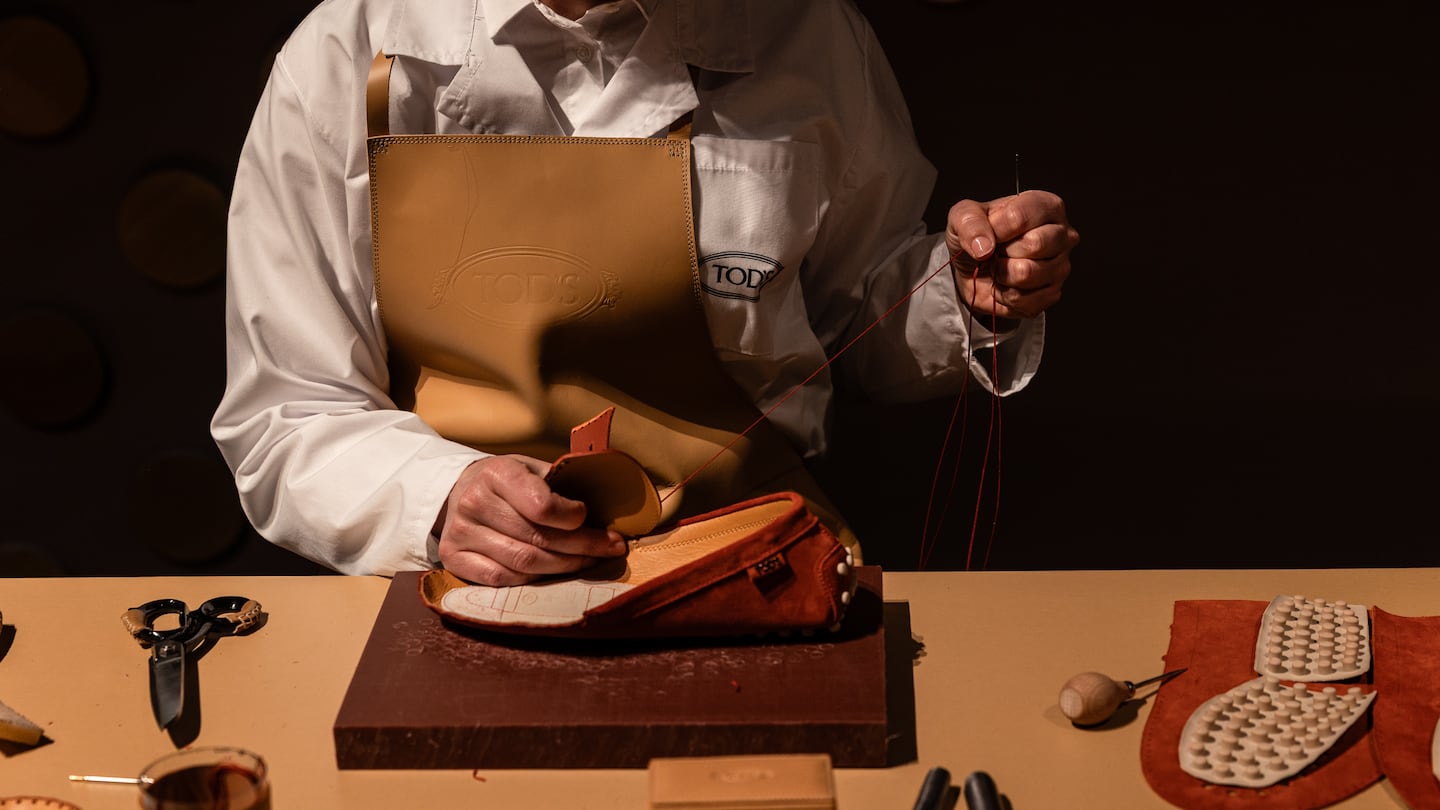 An artisan hand sews a shoe at an exhibition held by Tod’s during Milan Design Week in April.