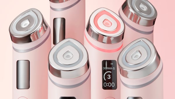 A collection of pink Medicube handheld skincare devices.