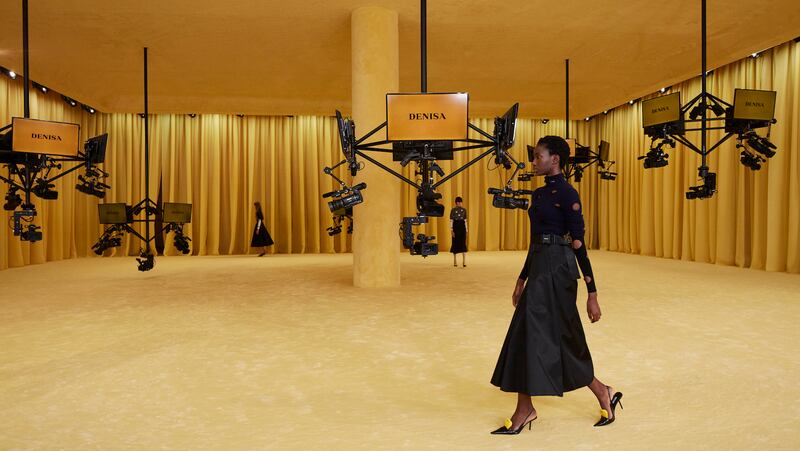 In Prada's first show after Raf Simons joined the group, models circled a panopticon robot equipped with dozens of cameras.
