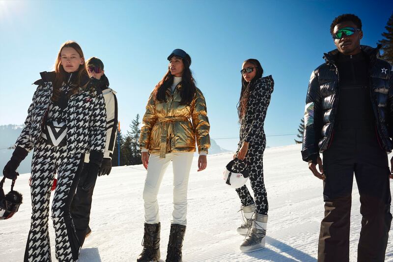 Models wearing Perfect Moment ski suits on a mountain