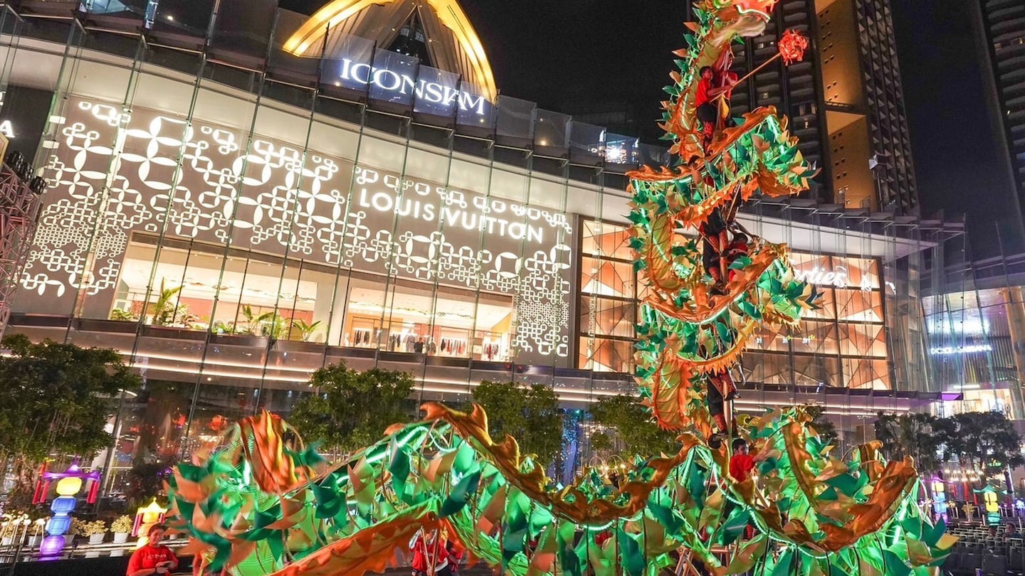 Louis Vuitton store celebrating Lunar New Year in China with a dragon outside the store.