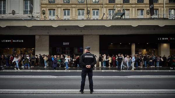 A French Policeman stands guard outside BHV Marais Department Store as shoppers queue ahead of the opening of Shein’s first physical store within the French department store.