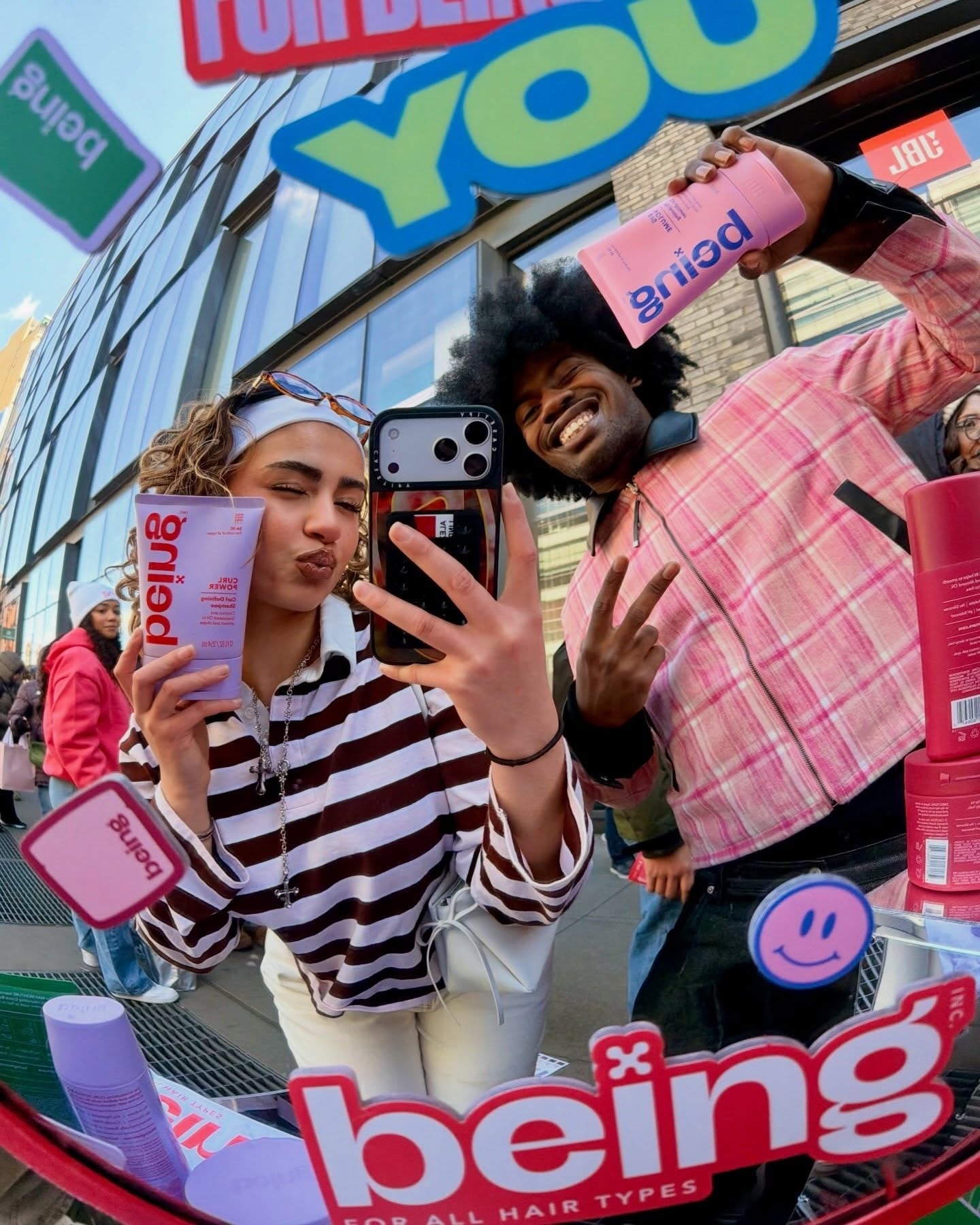 an instagram showing people holding Being haircare and taking a picture in a mirror