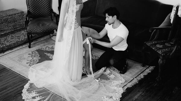 Mirror Palais designer and owner Marcelo Gaia at a fitting.