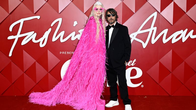 Kristen McMenamy and Pierpaolo Piccioli walk the red carpet at The Fashion Awards 2022.