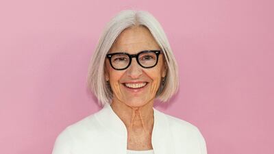 Eileen Fisher standing in front of a pink background.