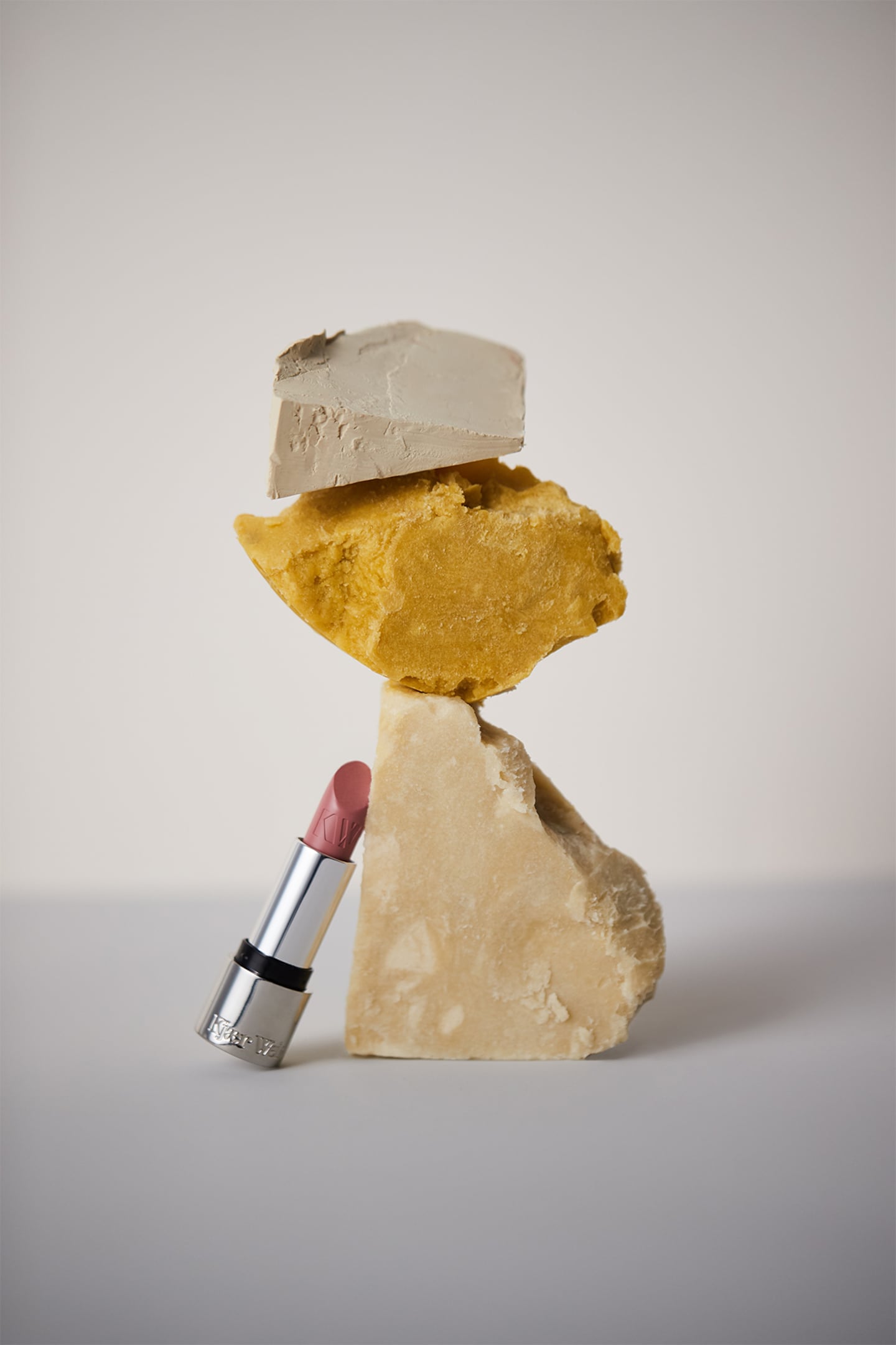 A lipstick perched against to rocks