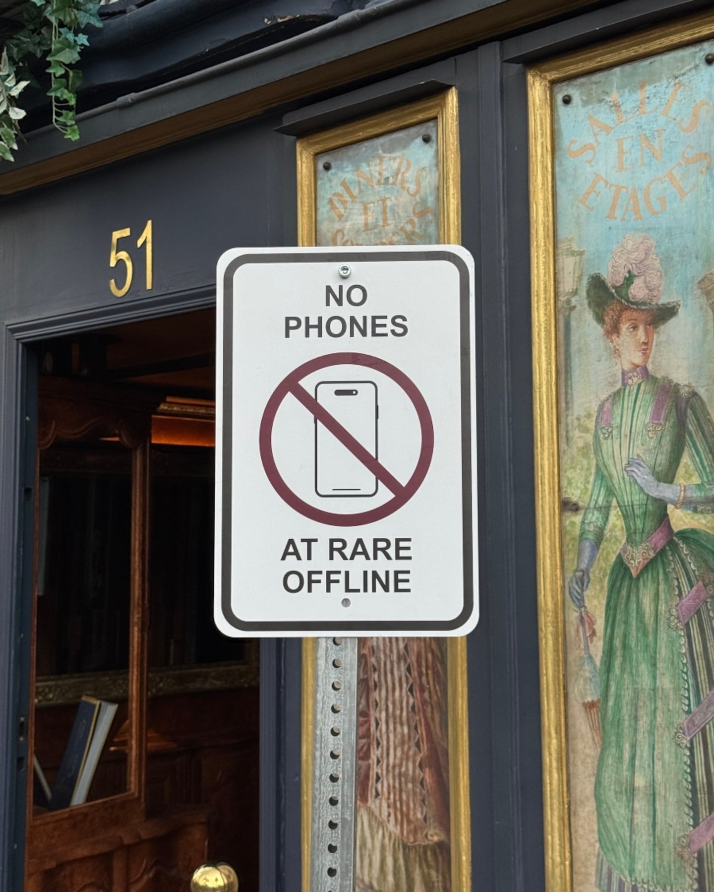 A sign at a Rare Beauty event reading "No Phones at Rare Offline."