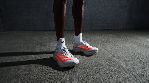 A runner standing in a room wears the Adizero Adios Pro Evo 2.
