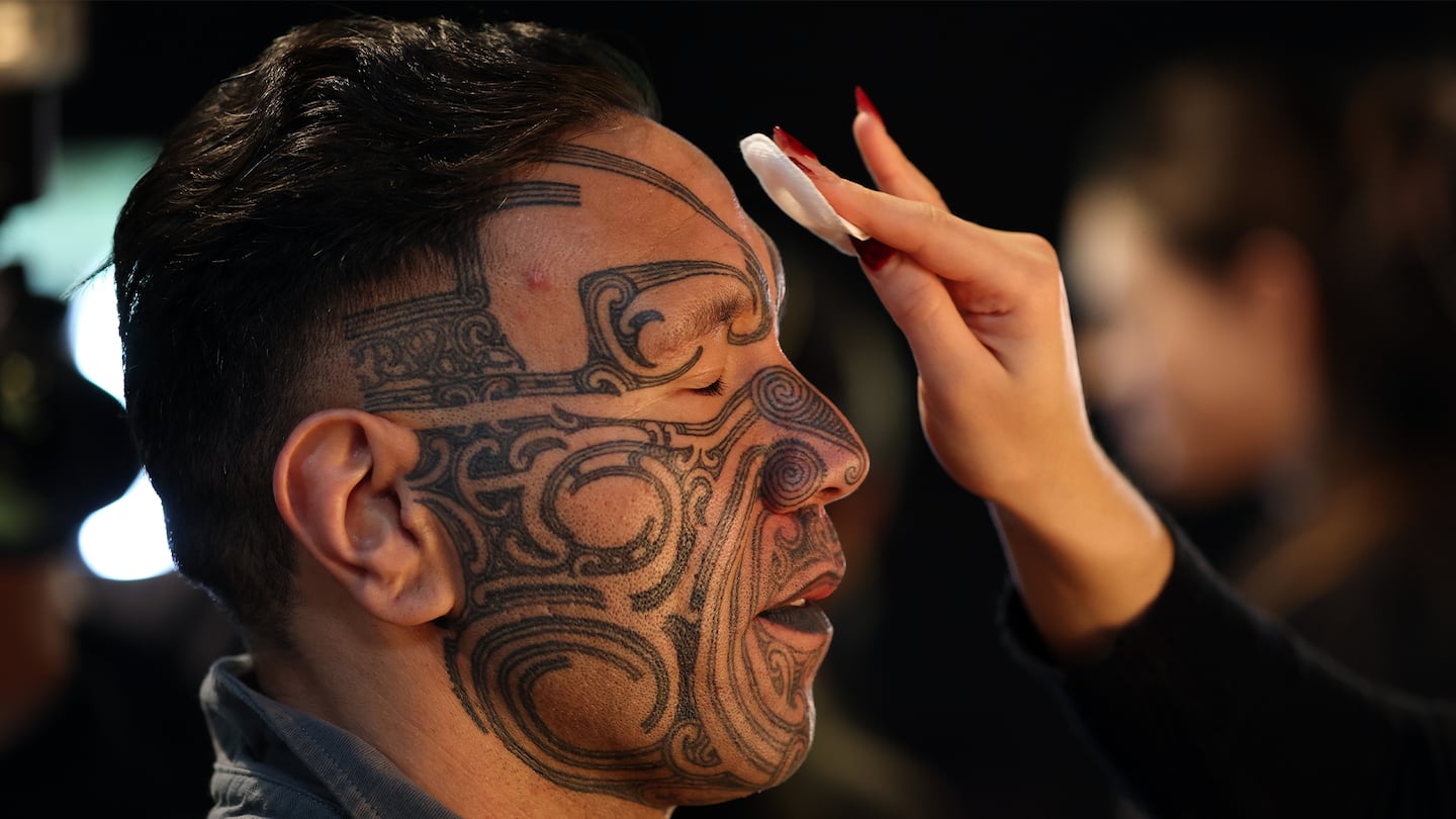 A model prepares backstage for the Kahui Collective show during New Zealand Fashion Week on August 20, 2026 in Auckland, New Zealand.