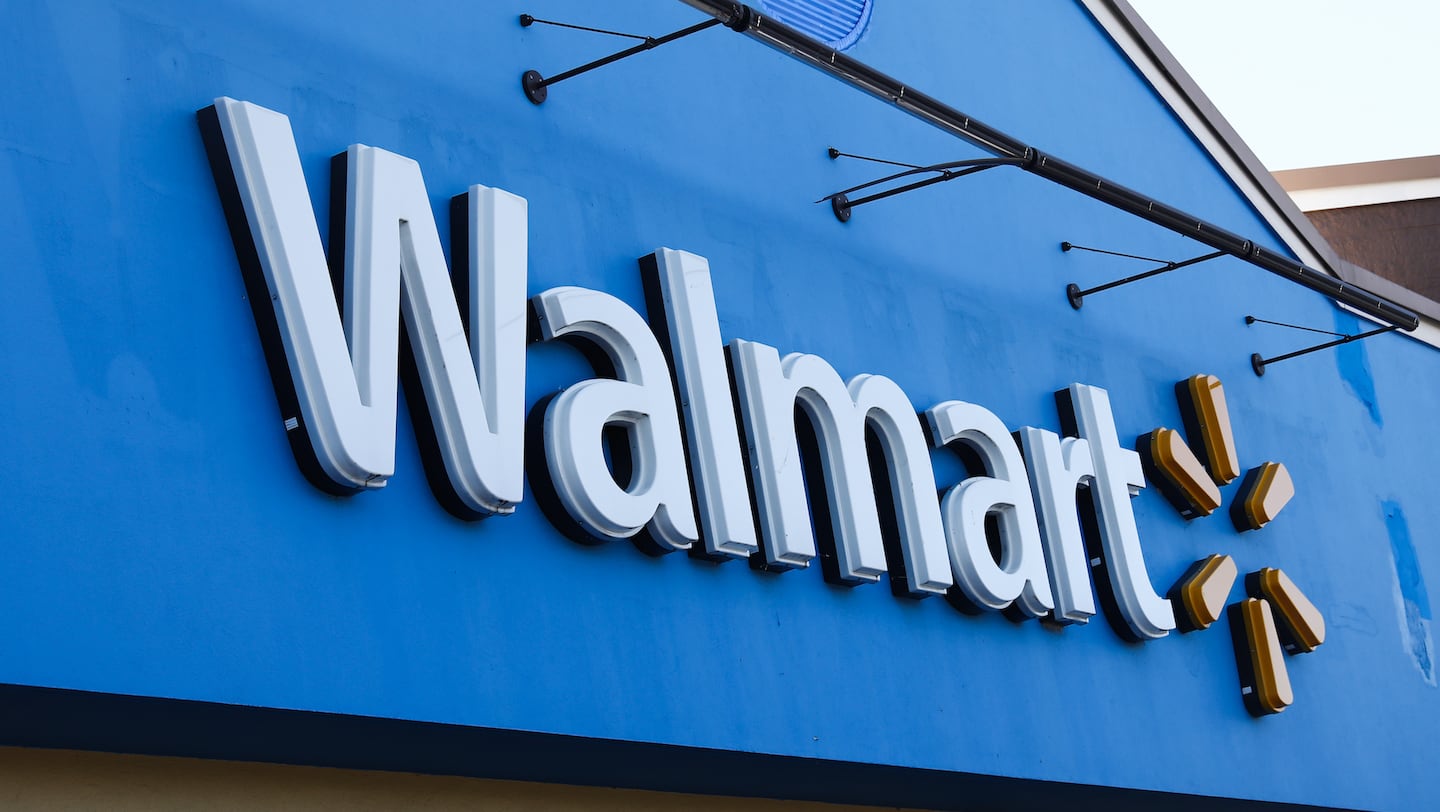 A large Walmart sign against a bright blue store front.