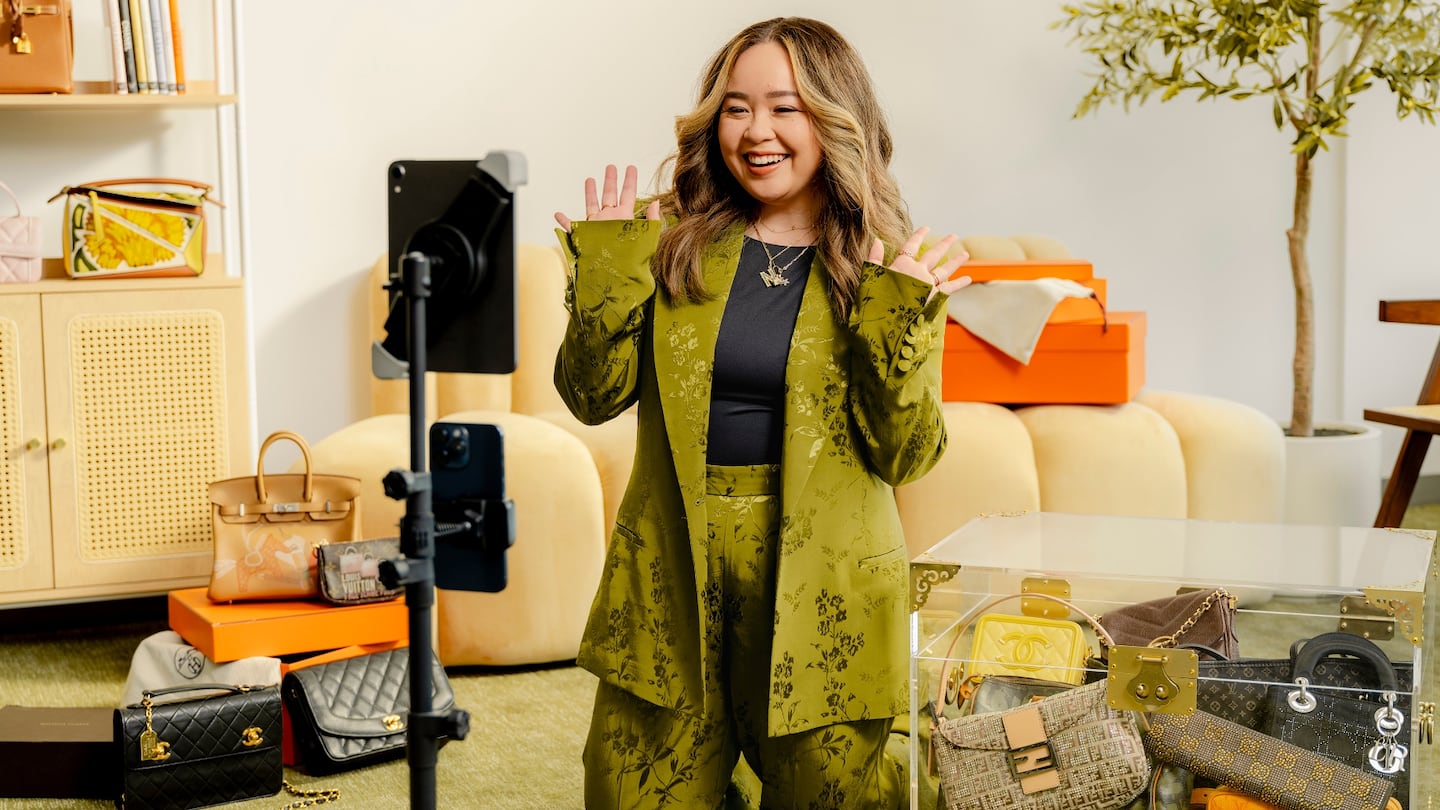 A person sells handbags during a livestream