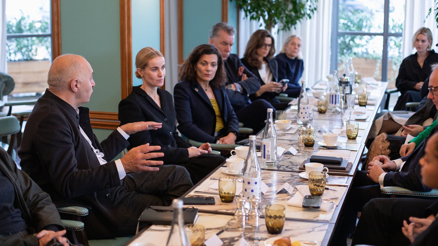 Attendees seated at a table for the BoF x CPHFW roundtable discussion on 'How Can the Fashion Industry Accelerate Systems Change?'
