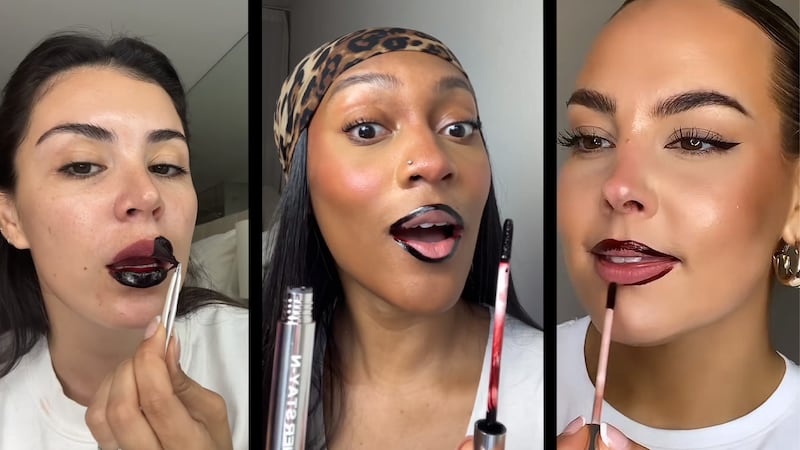 Three women applying lipstick