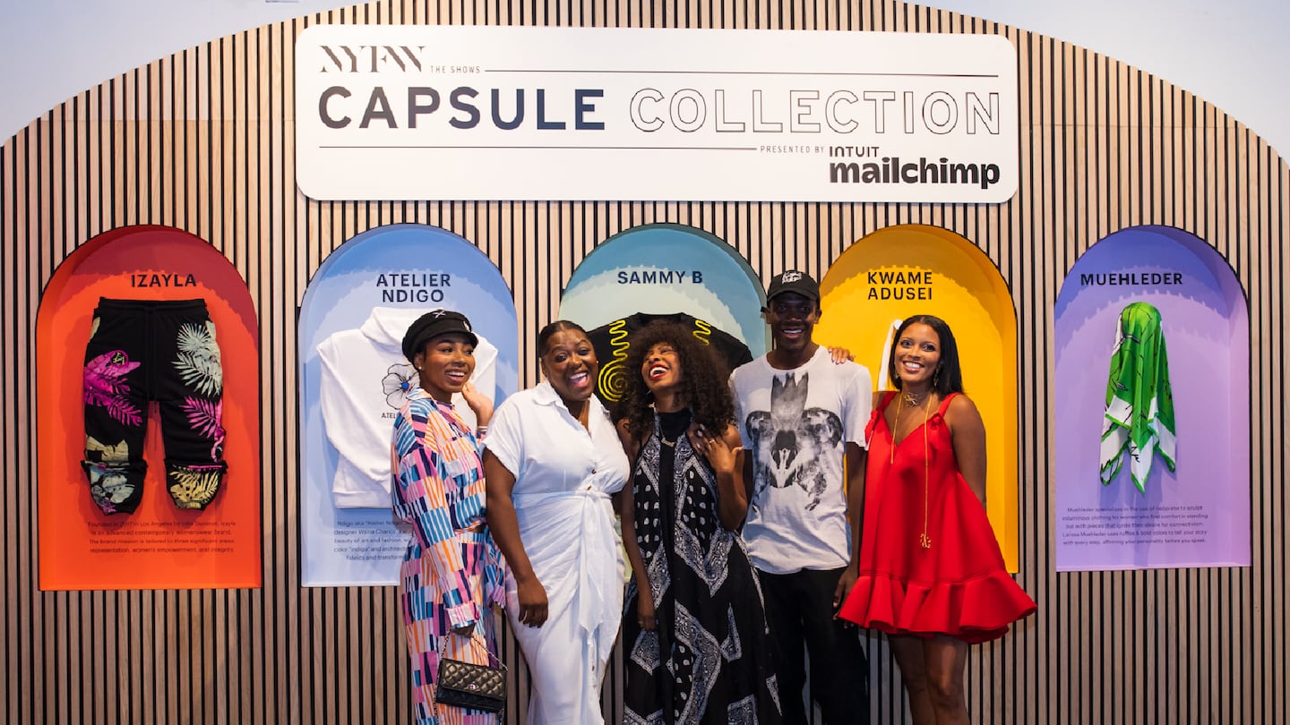 Five designers featuring in the NYFW Discovery Showroom stand as a group in front of their designs. From left:  I'sha Dunston of Izayla, Waïna Chancy of Ndigo Atelier, Sammy B., Kwame Adusei and Larissa Muehleder.
