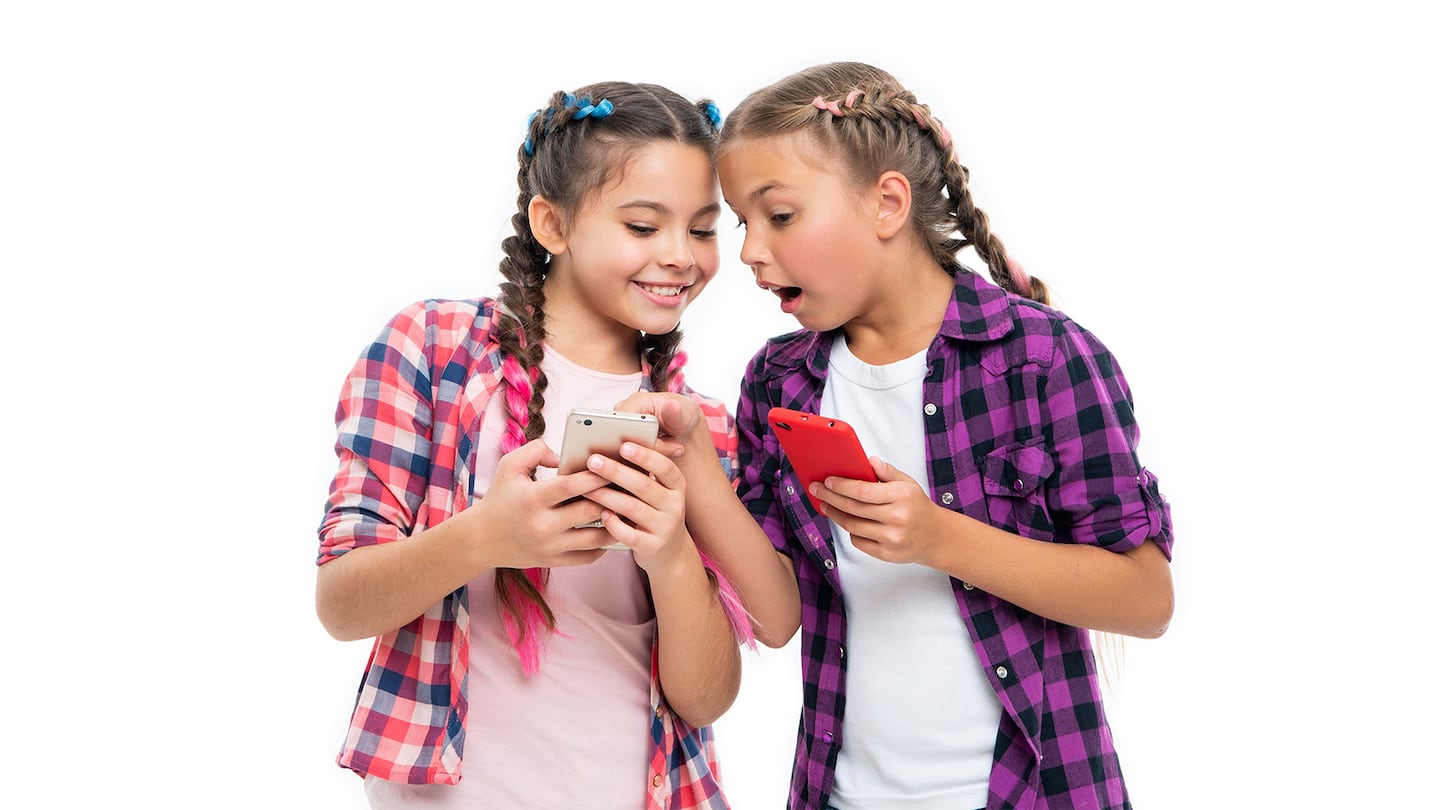 Two tween girls looking at something on the phone