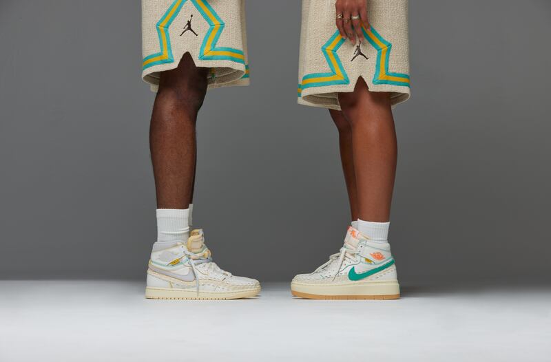 The legs of two models wearing the Union Jordan 1 sneakers stand in the centre of the frame facing each other.