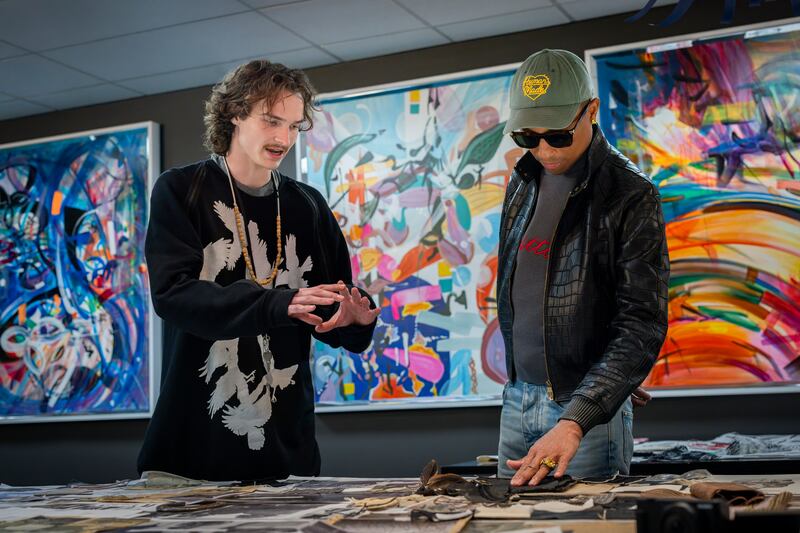 Pharrell Williams, men’s creative Director for Louis Vuitton, reviews a student's portfolio at SCAD.