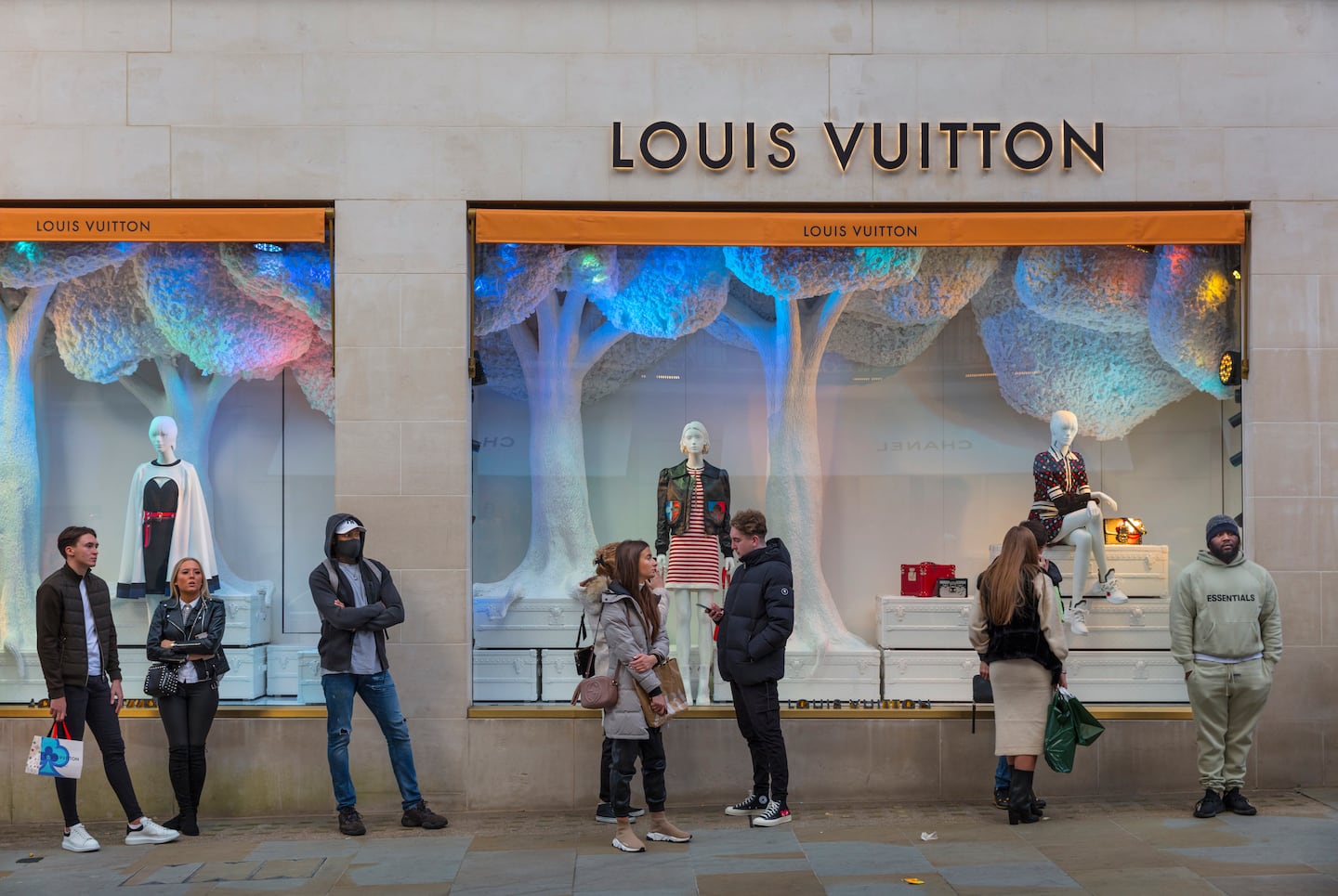 Masked shoppers queuing outside the Louis Vuitton store In London's Bond Street. Getty Images.