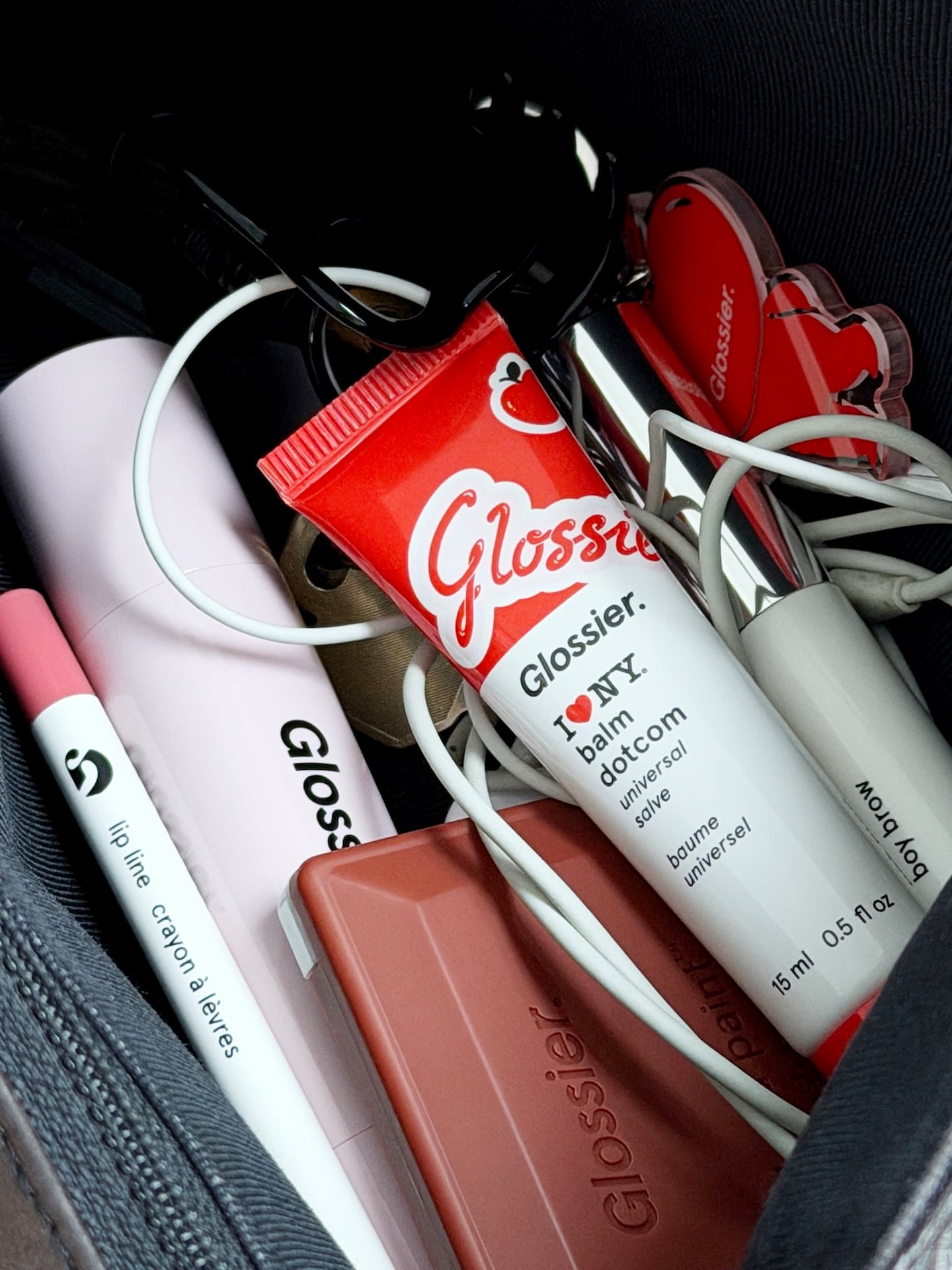 Glossier products in a makeup bag