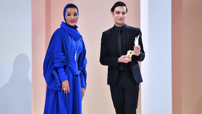 Her Highness Sheikha Moza bint Nasser and Mohamed Benchellal appear onstage at the Fashion Trust Arabia Prize Gala at the National Museum of Qatar in Doha.