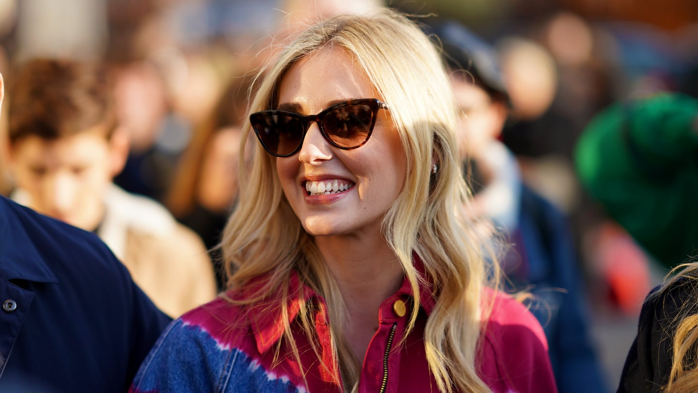 A blonde woman with sunglasses smiling