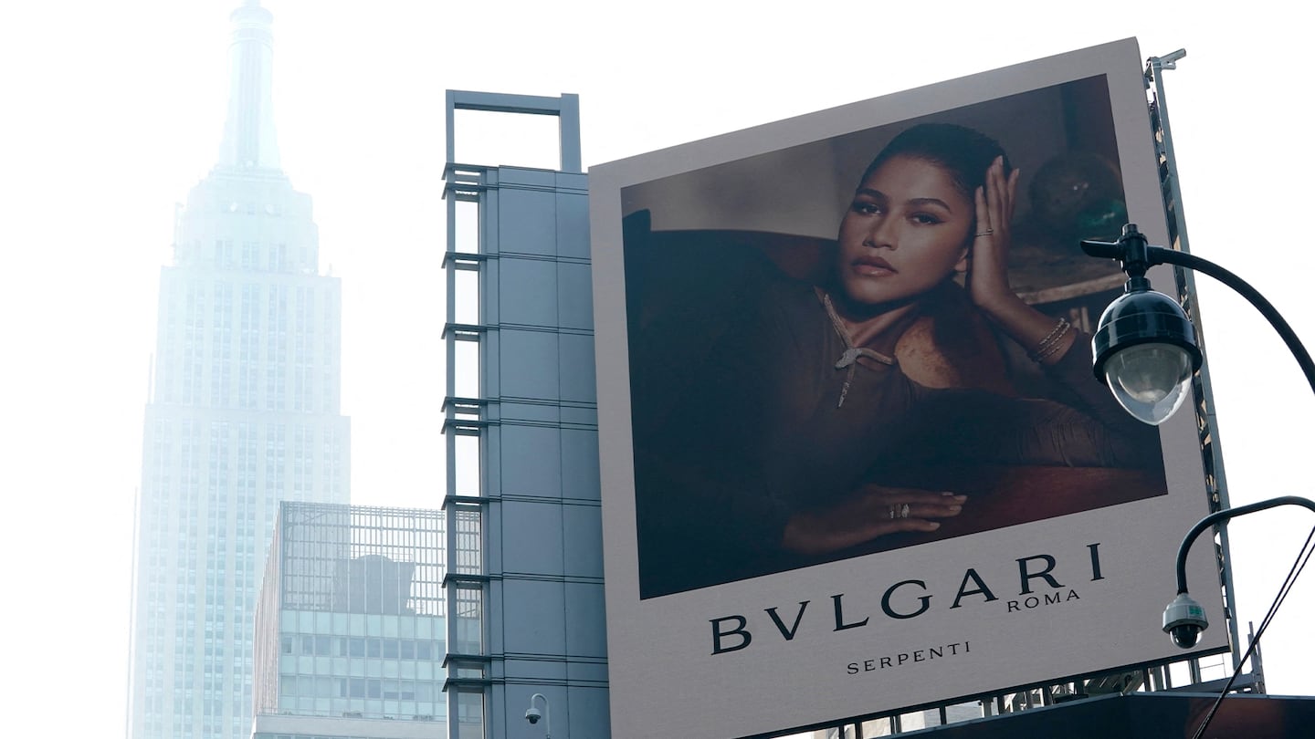 The Empire State Building cloaked in haze from Canadian wildfires with a large Bulgari billboard in the foreground.
