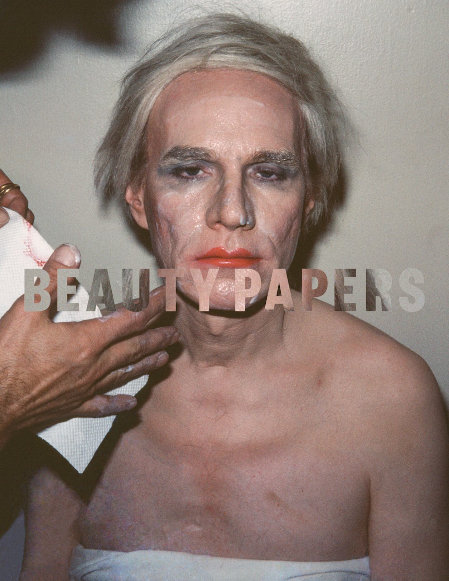 A cover for Issue 11 of Beauty Papers shows a previously unseen photo of Andy Warhol having his drag makeup removed.