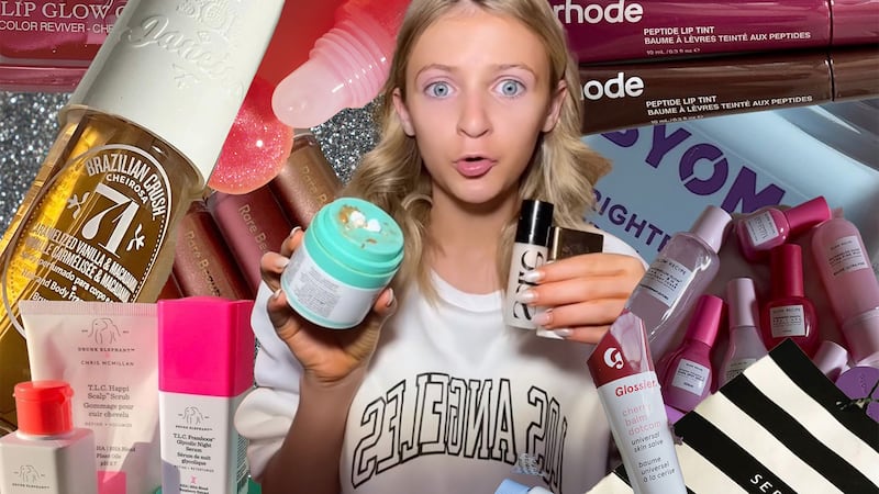 A tween girl surrounded by beauty products