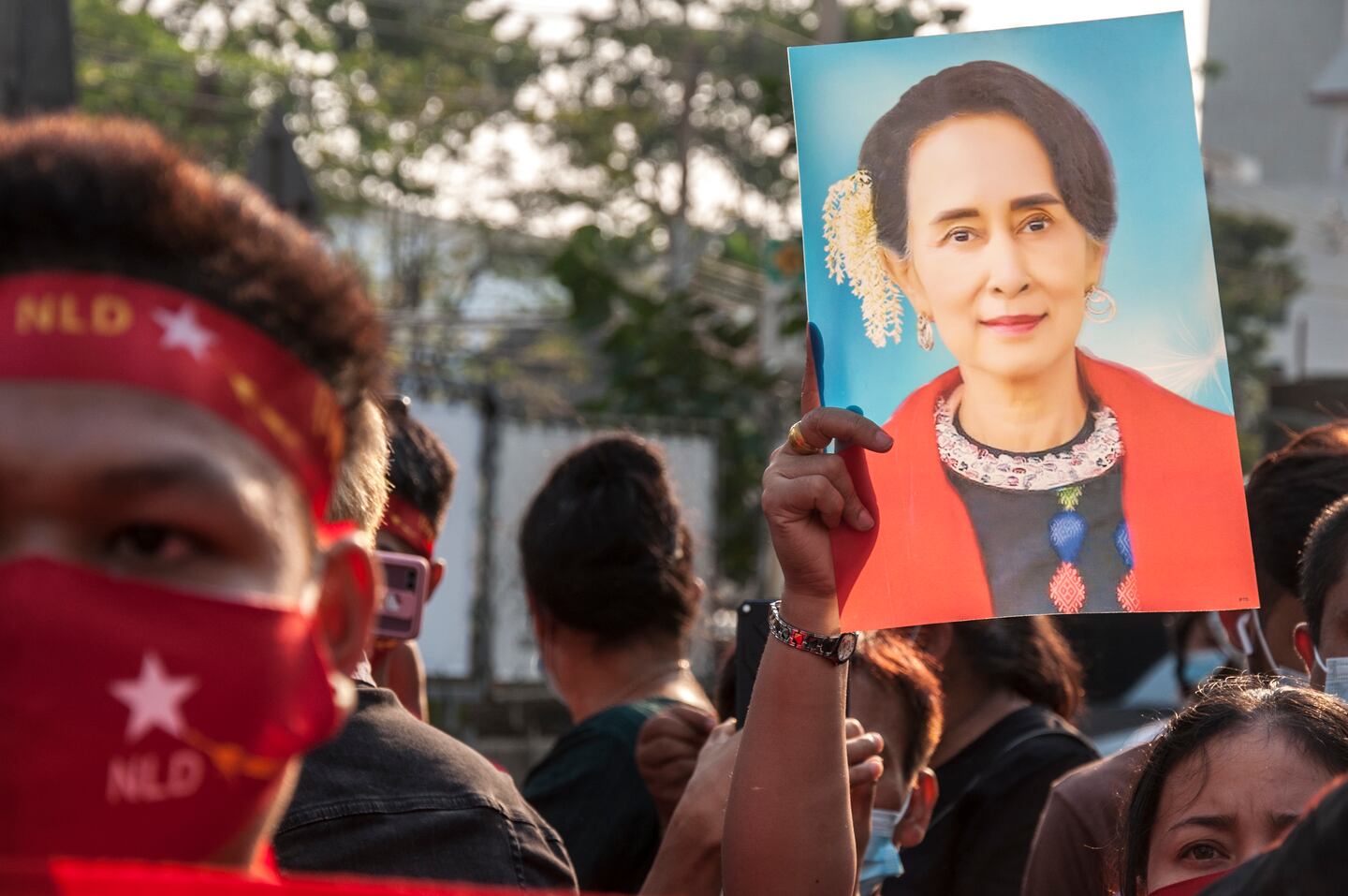 A supporter of Myanmar's National League for Democracy holds a portrait of politician Aung San Suu Kyi during a demonstration. Getty.