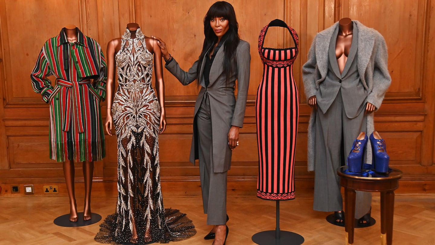 Model Naomi Campbell stands beside mannequins from her upcoming exhibition at the V&A.