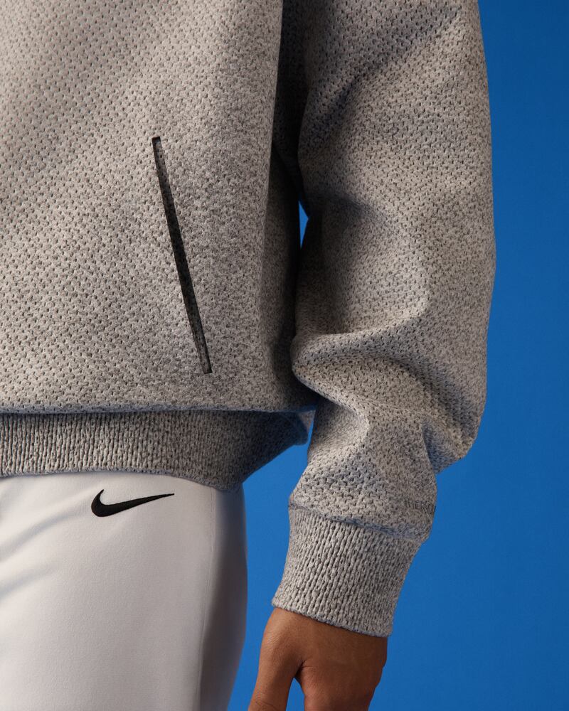 A detail shot of a Nike Forward hoodie showing the body and ribbing.