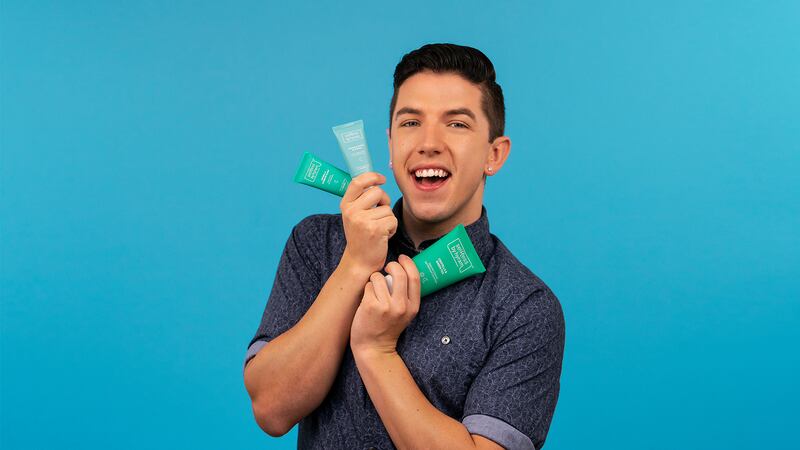 A man holding skin care products