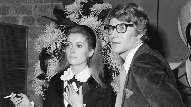 French actress Catherine Deneuve stands with fashion designer Yves Saint Laurent.