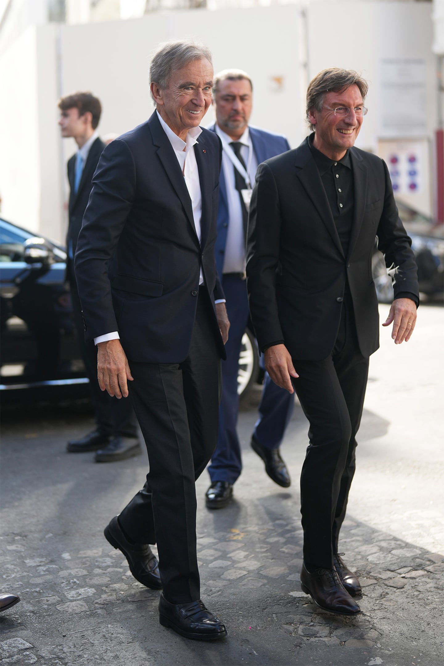 Two men in suits walking down the street
