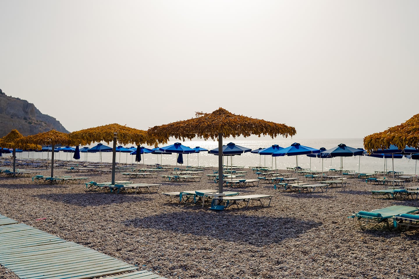 Empty beach with umbrellas and sunbeds.