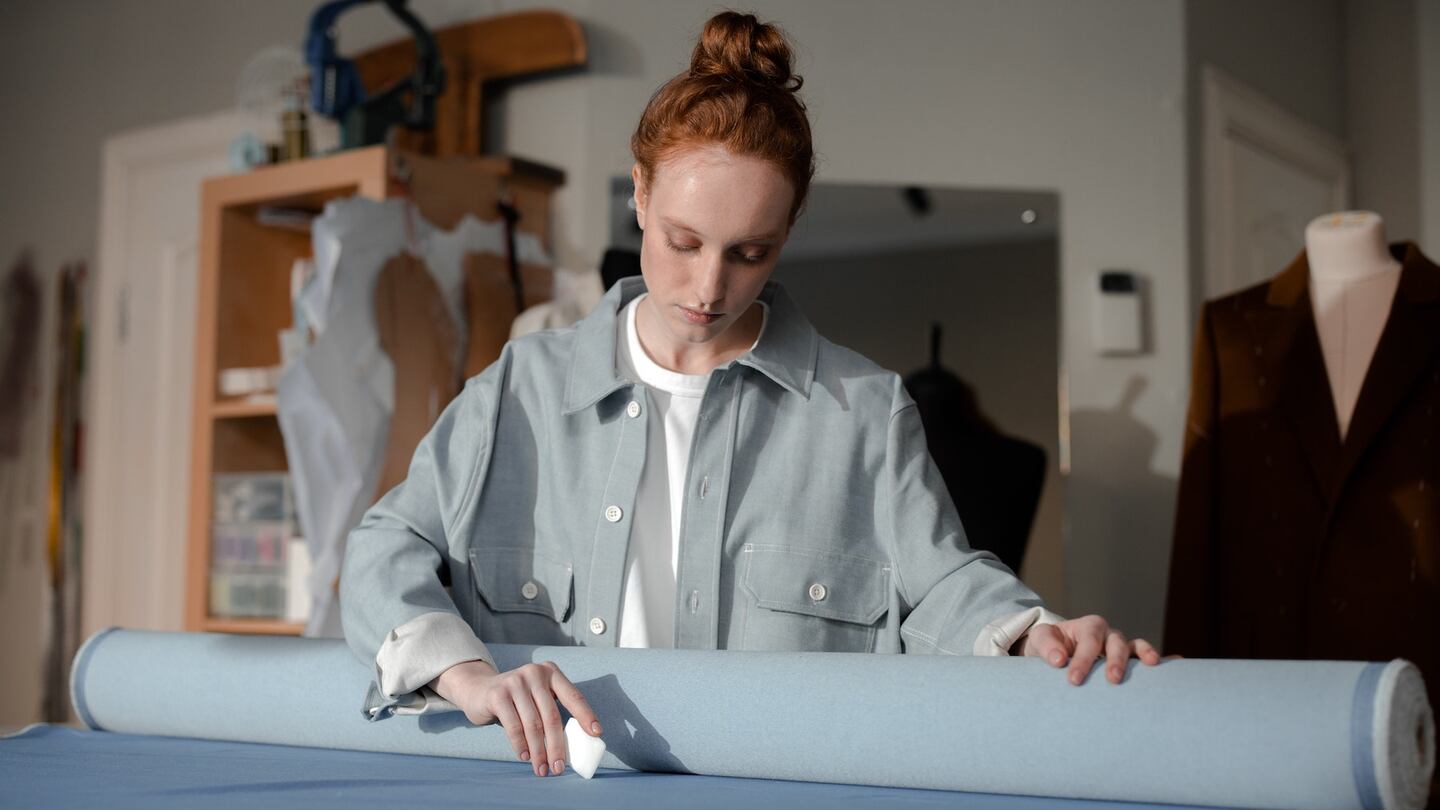 Design associate cutting fabric, BoF Careers 2022. Getty Images.