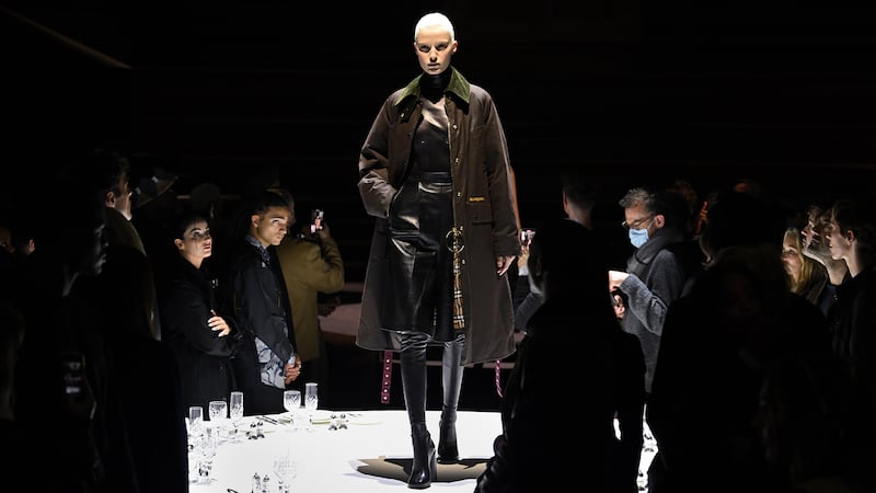 Riccardo Tisci’s Burberry Autumn/Winter 2022 show took place at the Methodist Central Hall in London’s Westminster where models walked on formally laid tables.