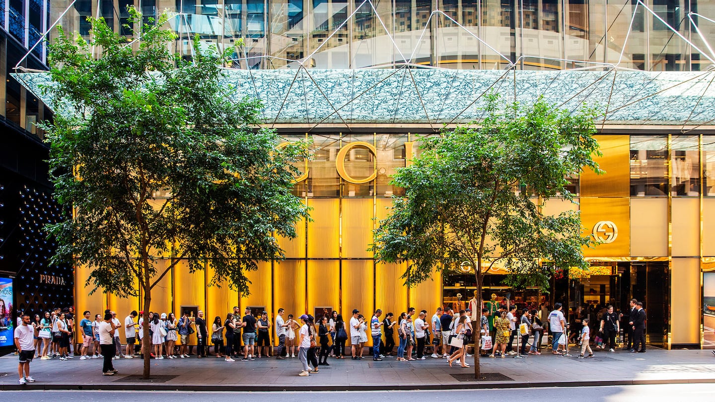 A long queue of shoppers line up outside a Gucci store in Sydney, Australia.
