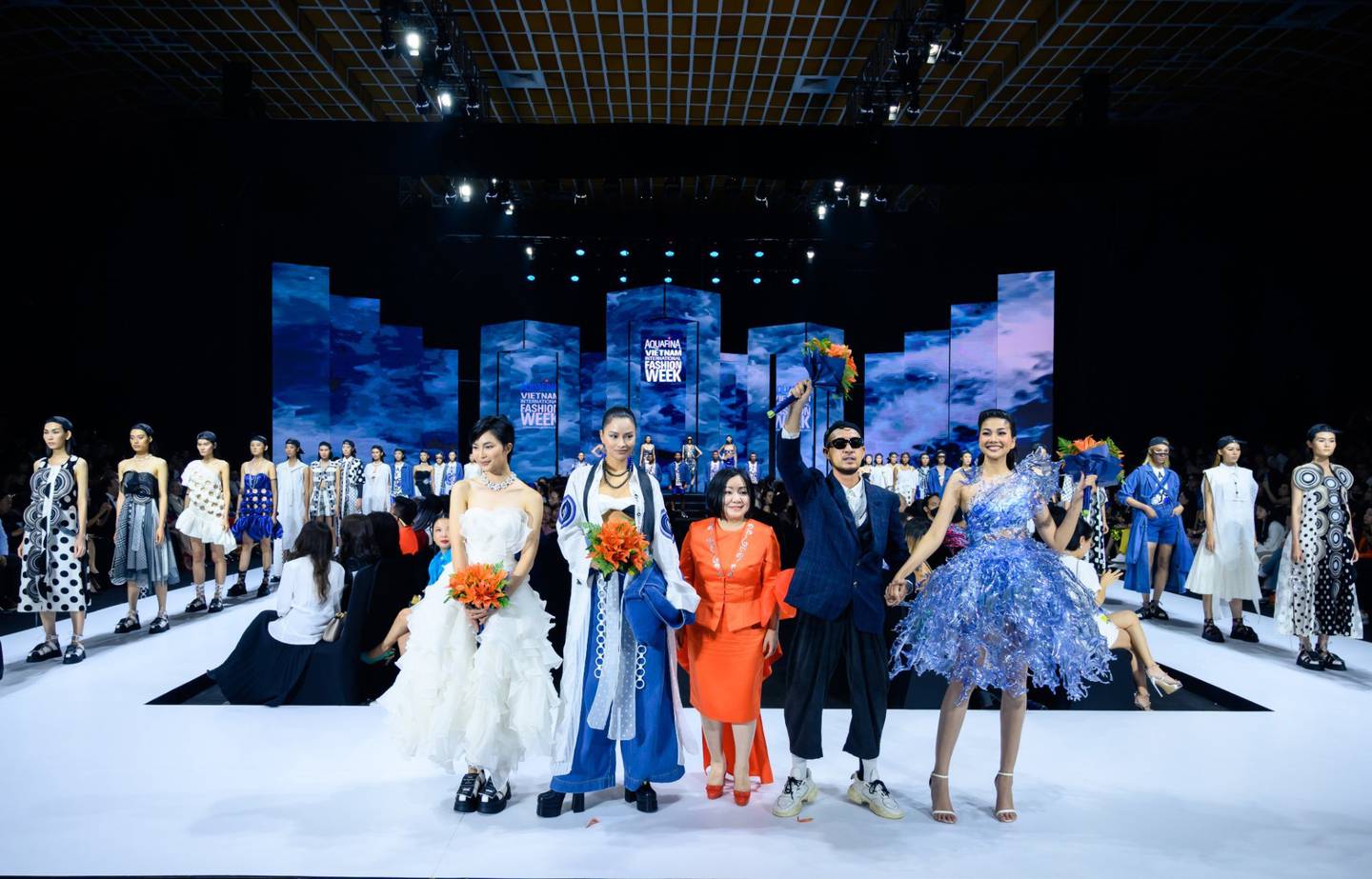 Vietnam International Fashion Week (VIFW) CEO Trang Le with designer Vo Cong Khanh and models in the May 2022 edition.