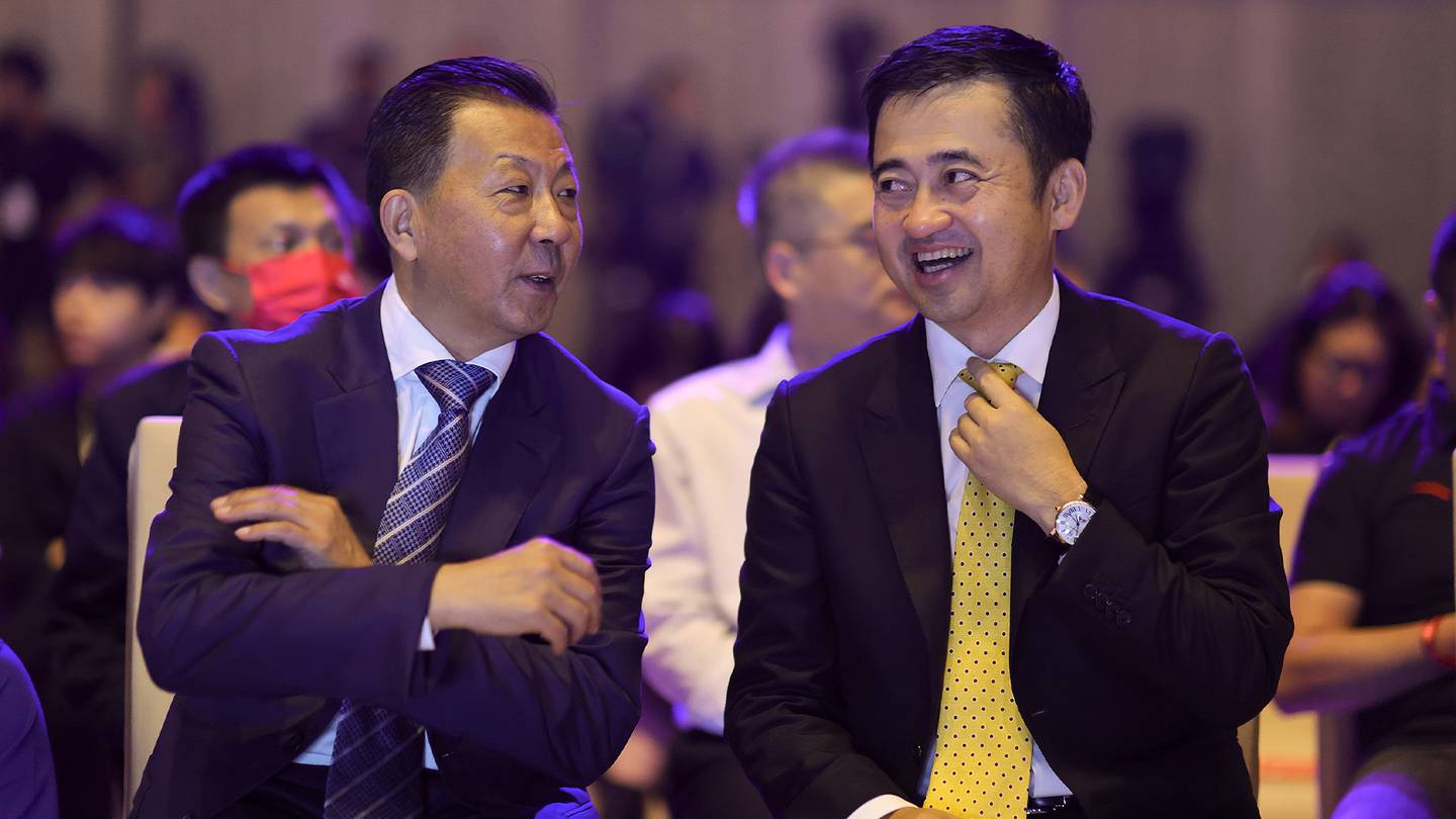 Anta Group chairman and CEO, Ding Shizhong (right) pictured here speaking with vice chairman of the Chinese Olympic Committee, Li Yingchuan, has seen his wealth grow considerably due to consumer and market trends in China this year. Getty Images.