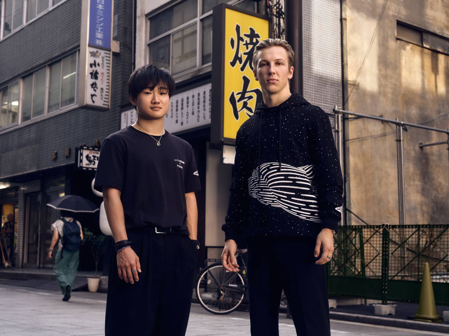 Alpha Tauri F1 drivers Yuki Tsunoda and Liam Lawson showing off the Red Bull-owned fashion line's collaboration with Californian artist Brendan Monroe.