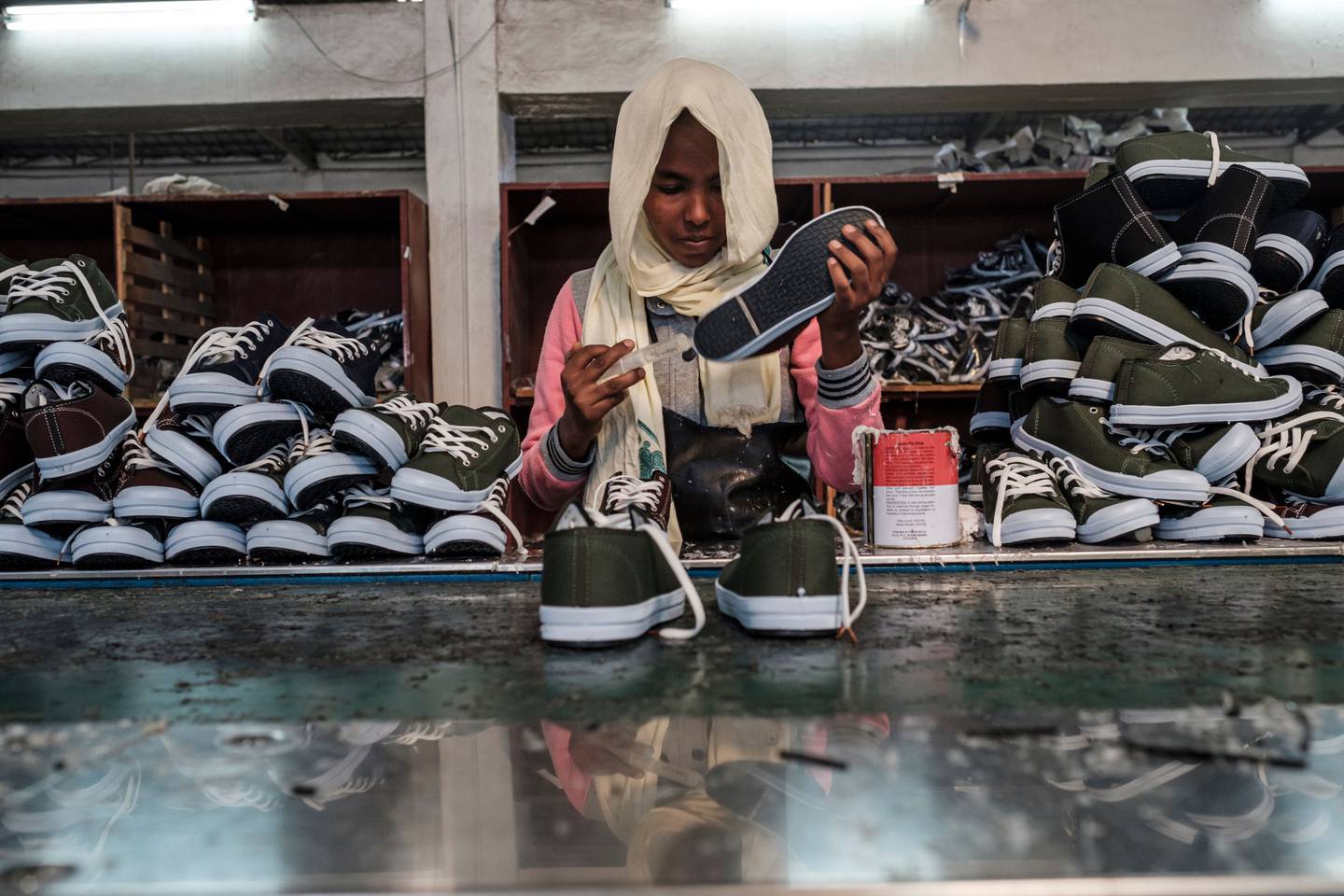 A worker at an assembly line at a shoe factory belonging to the Mohan Group in the area of Gelan, Ethiopia, in December 2019.