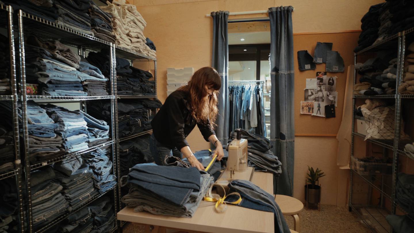 Anna Foster preparing used jeans for upcycling in E.L.V Denim’s London studio.