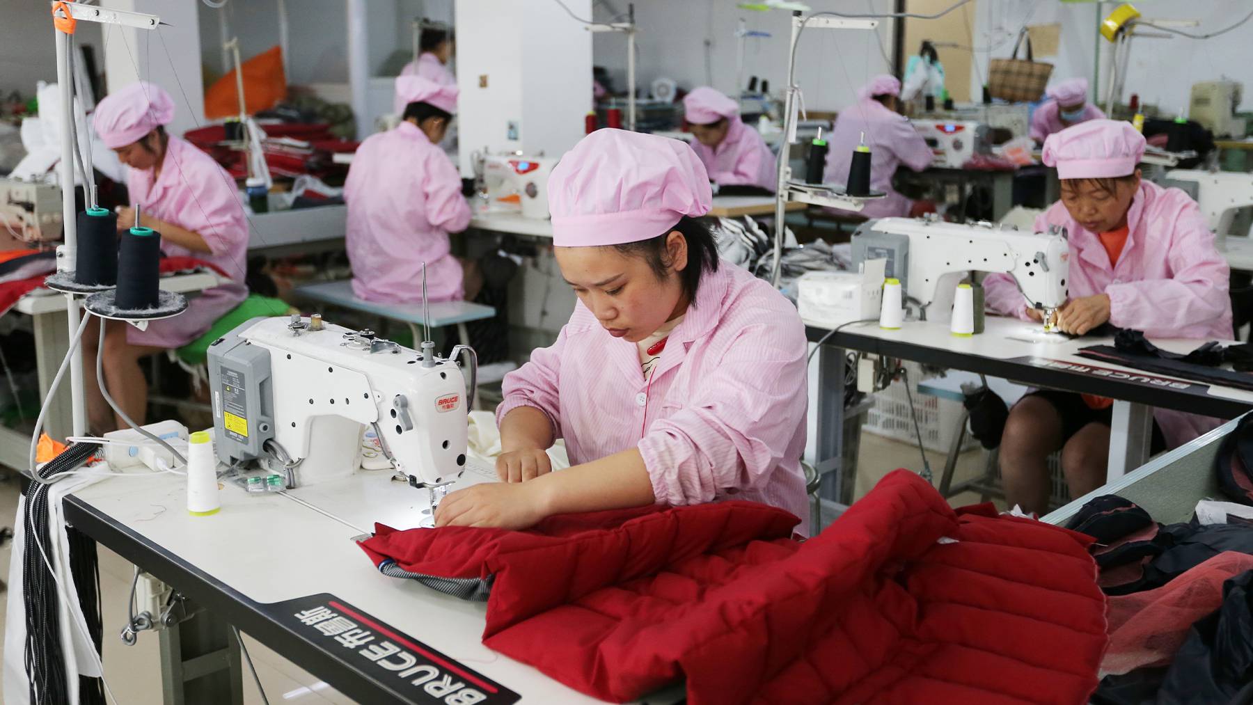 Women work in a garment factory in Suixi county in central China's Anhui province. Getty Images.