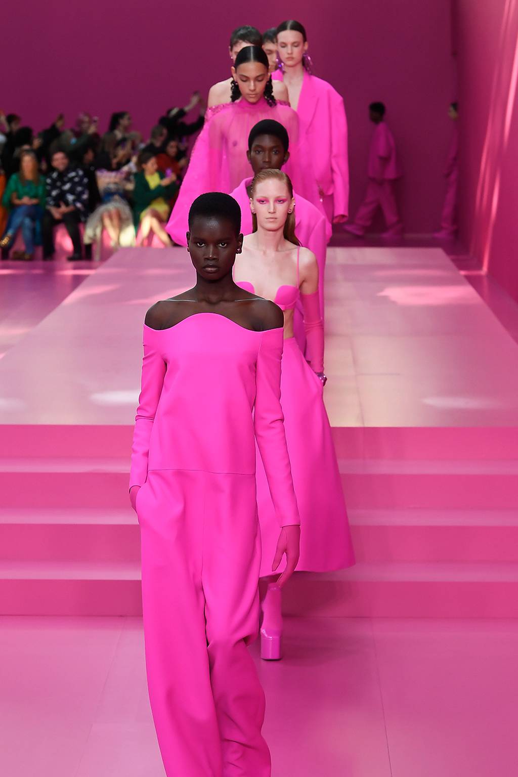 Models walk the runway at Valentino's Autumn/Winter 2022 show, which has helped set off a pink flurry in fashion.